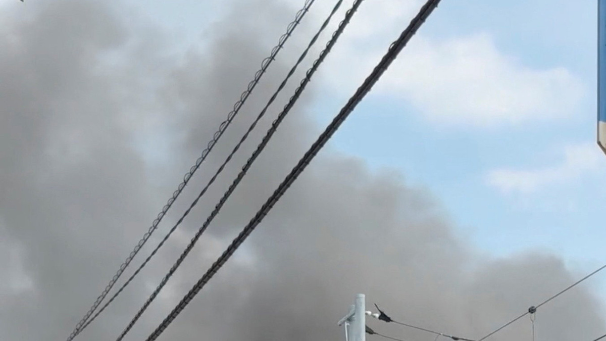 People watch smoke rising from a fire at a primary school in Tokyo, Japan, June 19, 2026, in this still image obtained from social media video. @Ayuthin0217 via X/via REUTERS