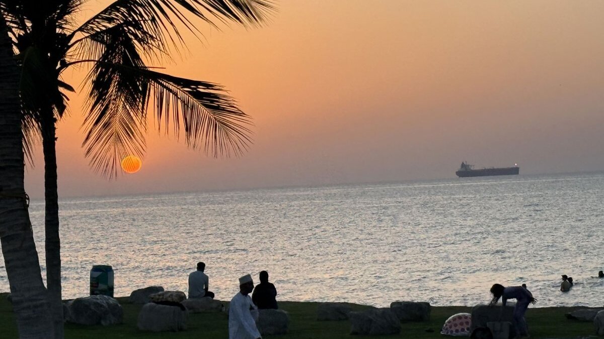 People enjoy the beach in May as a vessel is seen waiting to cross the Strait of Hormuz in the Arabian Sea off Muscat, Oman. On Monday, the U.S. Treasury Department said that it authorized sales of Iranian oil for 60 days amid ongoing talks between the two countries. Photo by Ismael Mohamad/UPI