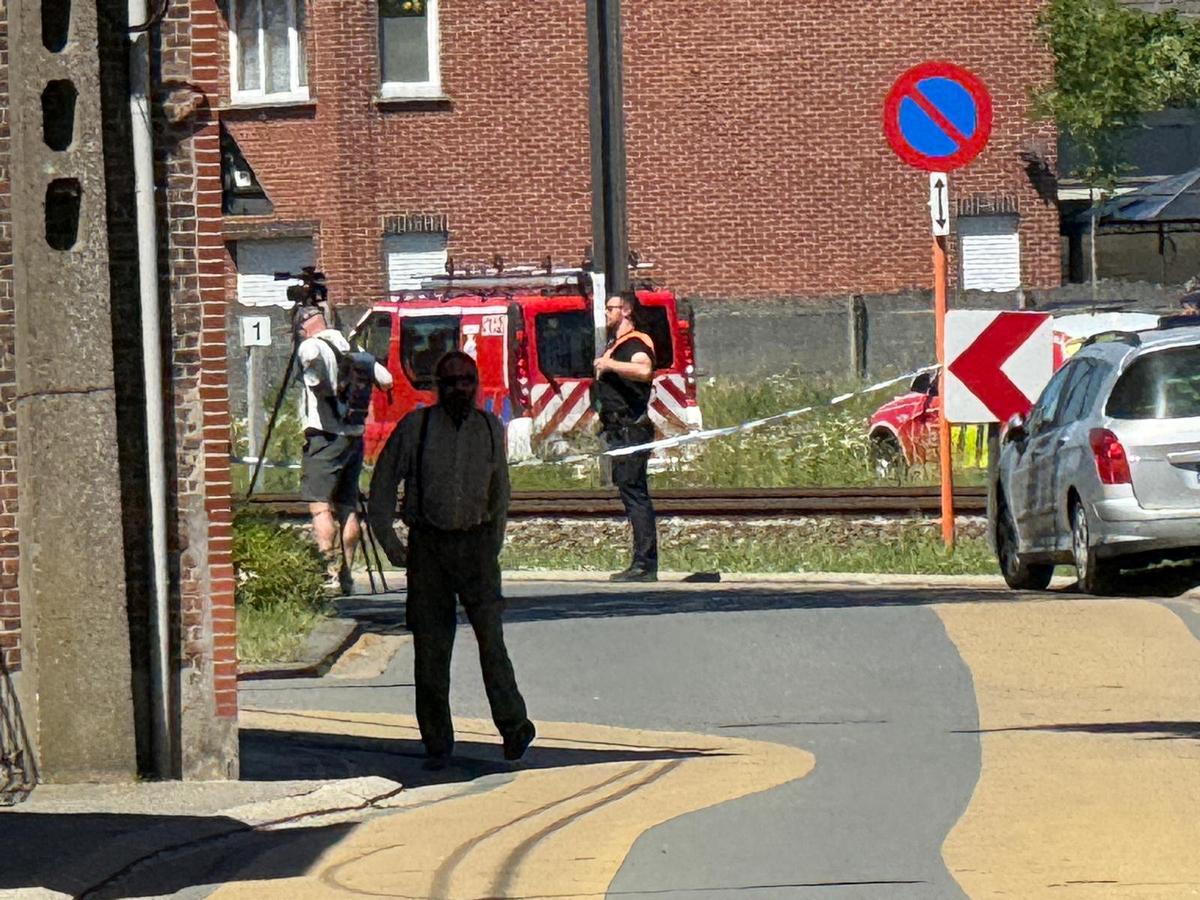 Emergency vehicles operate near the scene where a school bus was struck by a train at a level crossing leading to multiple casualities, near the town of Buggenhout, Belgium, May 26, 2026. REUTERS/Bart Biesemans
