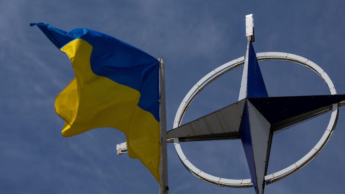 A Ukrainian national flag rises in front of the NATO emblem, amid Russia's attack on Ukraine, in central Kyiv, Ukraine July 11, 2023. REUTERS/Valentyn Ogirenko