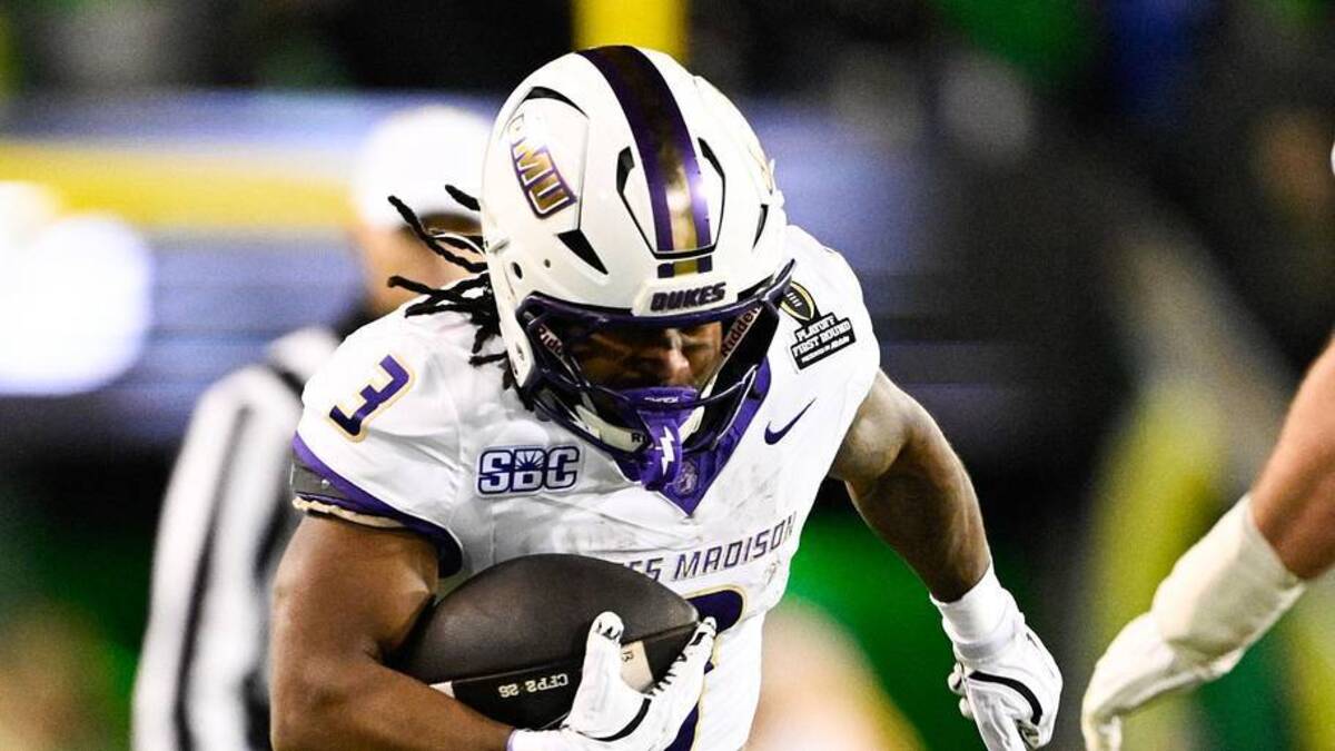  Dec 20, 2025; Eugene, OR, USA; James Madison Dukes running back Wayne Knight (3) rushes as Oregon Ducks defensive back Aaron Flowers (21) defends during the second quarter at Autzen Stadium. Mandatory Credit: Troy Wayrynen-Imagn Images | Troy Wayrynen-Imagn Images 