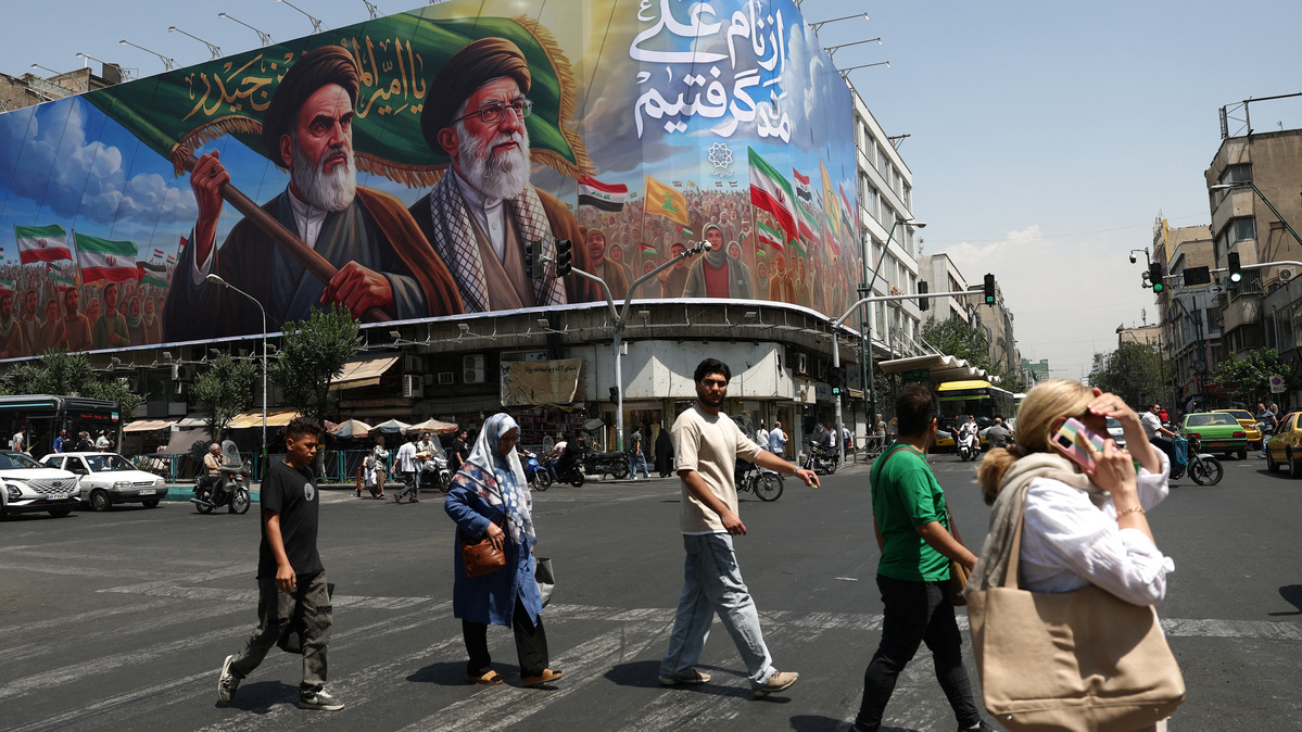 People walk past a billboard depicting the late leader of the Islamic Revolution, Ayatollah Ruhollah Khomeini, and the late Iran's Supreme Leader Ayatollah Ali Khamenei, on a street in Tehran, Iran June 6, 2026. Majid Asgaripour/WANA (West Asia News Agency) via REUTERS