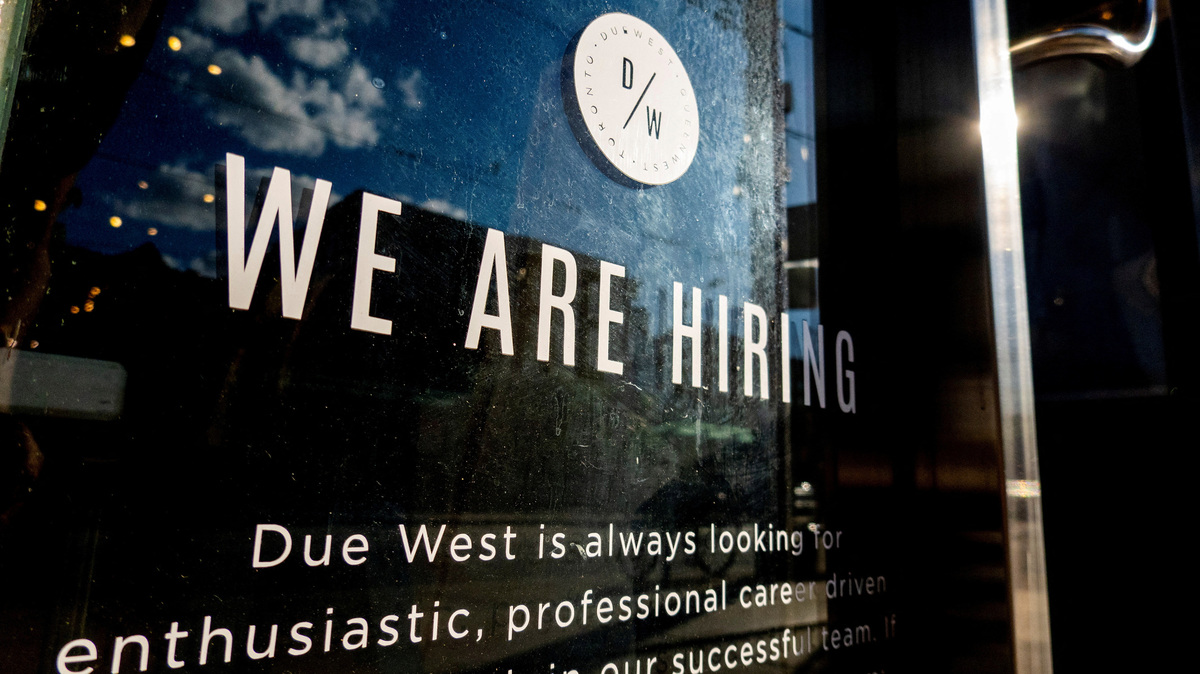 FILE PHOTO: A help wanted sign at a store along Queen Street West in Toronto Ontario, Canada June 10, 2022. REUTERS/Carlos Osorio/File Photo