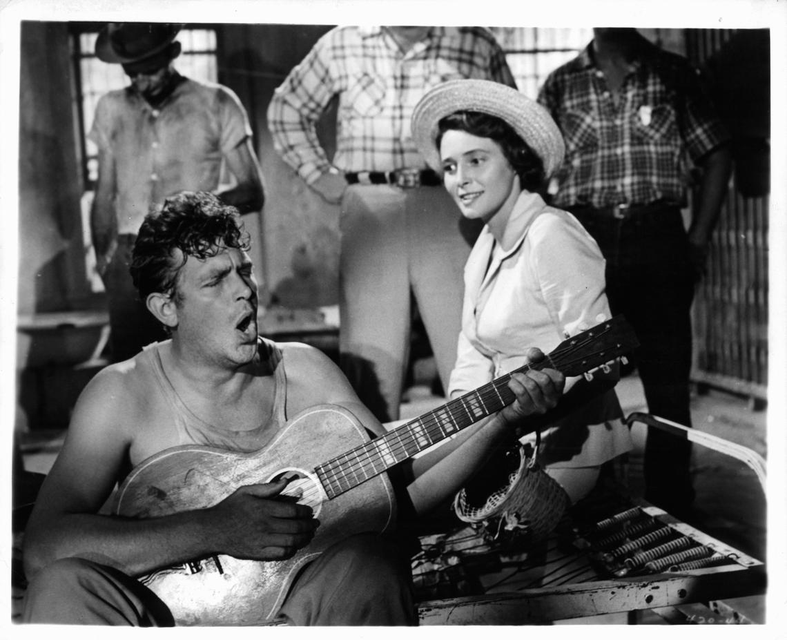 Andy Griffith playing guitar as Patricia Neal watches in a scene from the film ‘A Face In The Crowd’, 1957.Warner Brothers/Getty Images