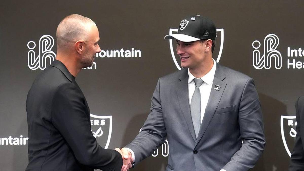  Apr 24, 2026; Henderson, NV, USA; Las Vegas Raiders quarterback Fernando Mendoza (right) shakes hands with general manager John Spytek at introductory press conference at Intermountain Health Performance Center after being selected as the No. 1 pick in the 2026 NFL Draft. Mandatory Credit: Kirby Lee-Imagn Images | Kirby Lee-Imagn Images 