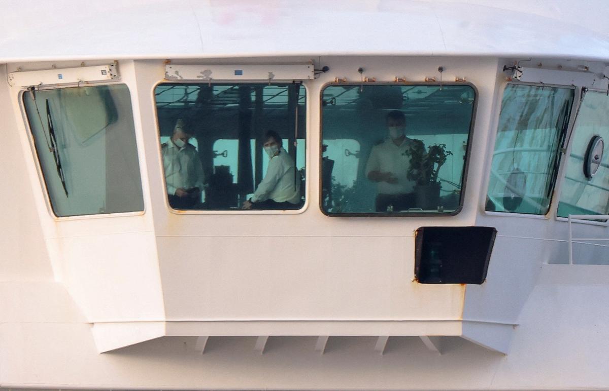 Crew members aboard the cruise ship MV Hondius at the port of Granadilla de Abona after being affected by a hantavirus outbreak in Tenerife, Spain, May 10, 2026. REUTERS/Hannah McKay
