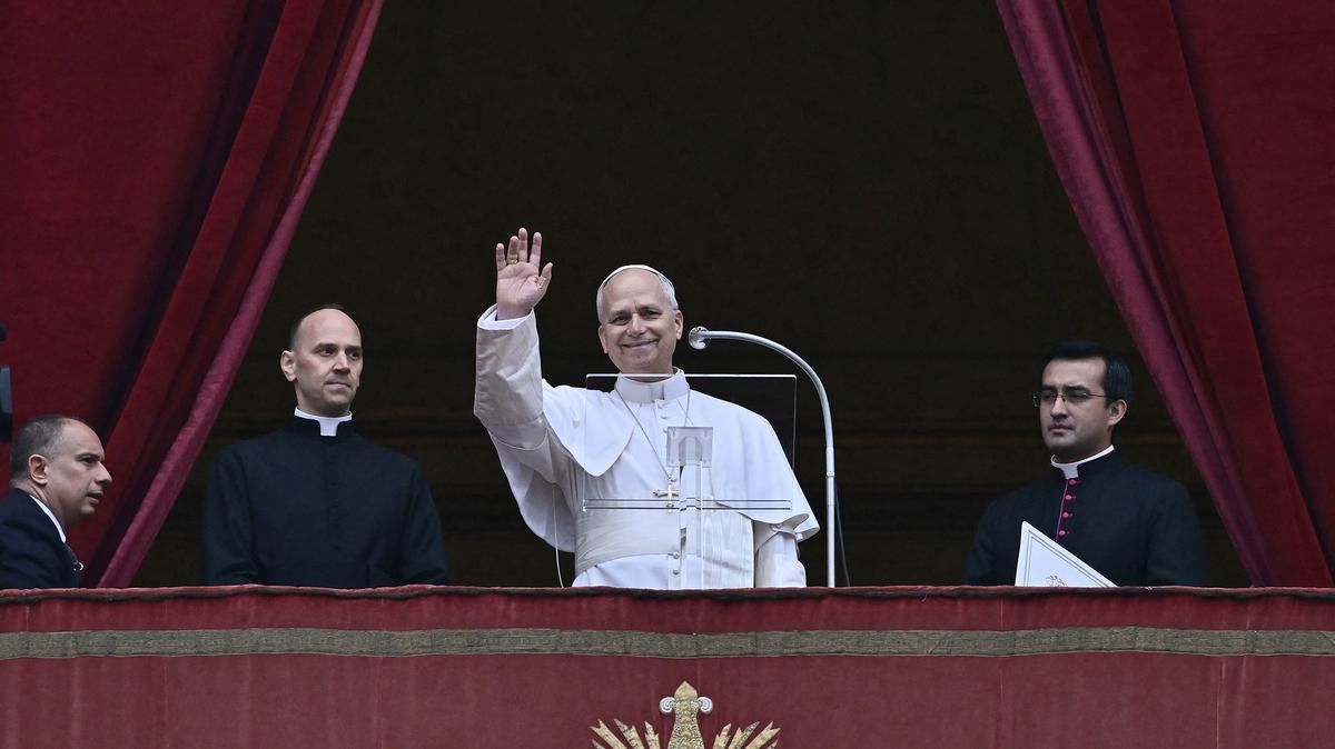 Pope Leo XIV waves to the crowd from the central balcony of St Peter's basilica overlooking St. Peter's square during the Angelus prayer in The Vatican on Jan. 6, 2026. (Filippo Monteforte/AFP via Getty Images/TNS)
