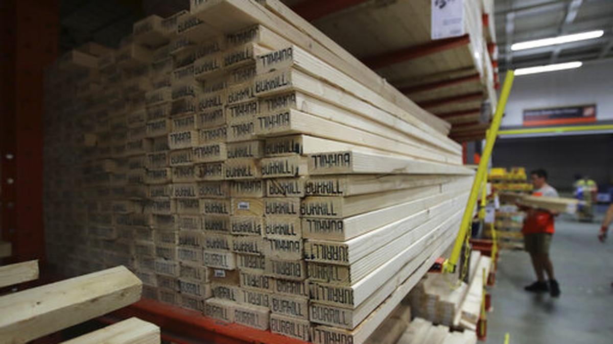 FILE - In this July 11, 2019, file photo lumber is stacked at the Home Depot store in Londonderry, N.H. The Home Depot Inc. on Tuesday, Aug. 20, reported fiscal second-quarter net income of $3.48 billion. Home Depot cut its sales expectations for the year as lumber prices slid and the company braces for the potential impact of tariffs on its customers.