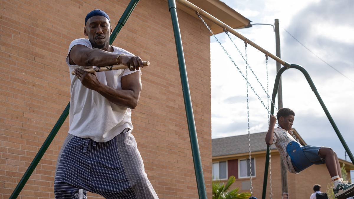 Mahershala Ali (left, with Jahleel Kamara) stars as a religious hitman who, after the death of his wife, has to keep his