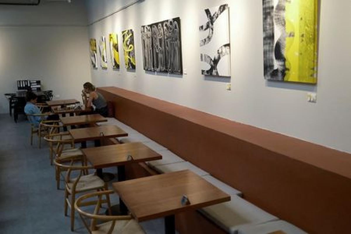 Customers sit with empty tables visible at Lila Molino restaurant in Dubai, United Arab Emirates, April 28, 2026. REUTERS