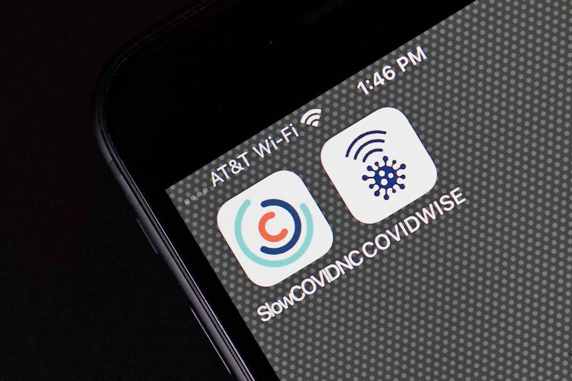 COVID-19 notification apps for North Carolina, SlowCOVIDNC and Virginia, COVIDWISE are shown on a smart phone Friday, Dec. 4, 2020 in Raleigh, N.C.  The tool is designed to notify people who might have been exposed to the coronavirus — without disclosing any personal information. 