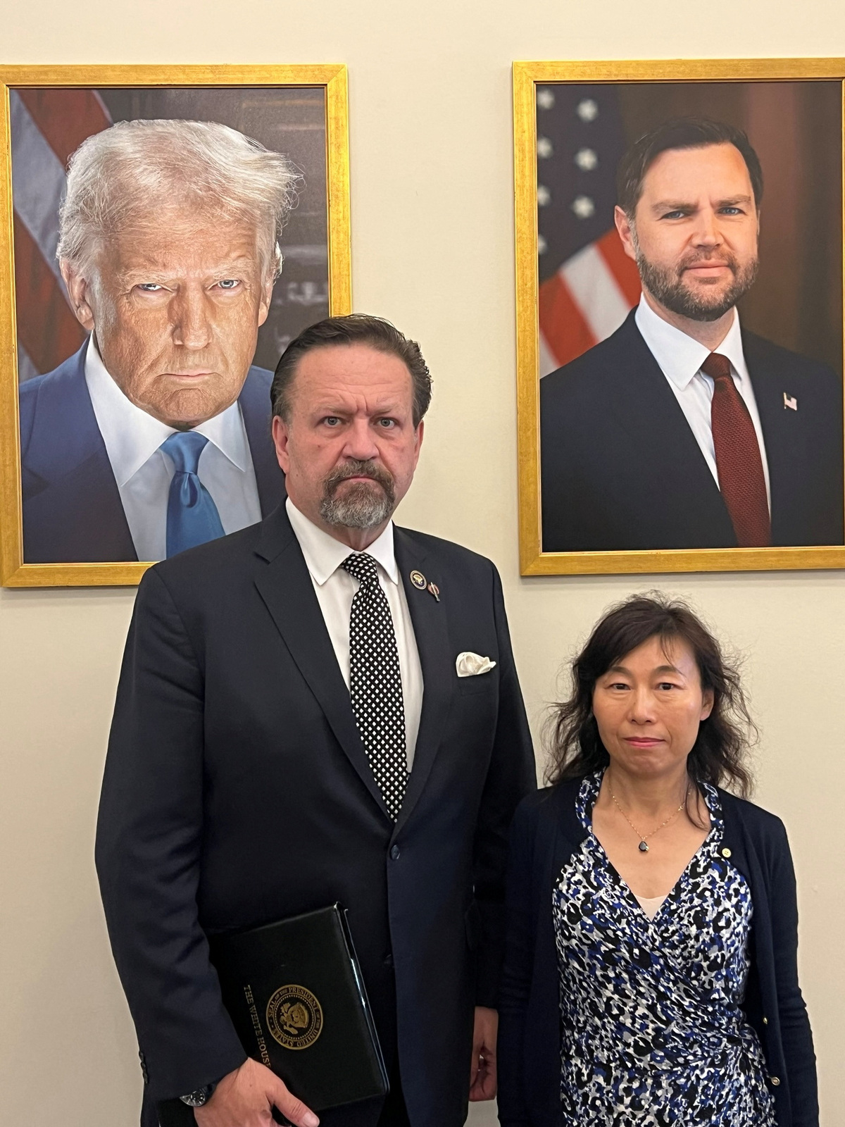 Dr. Yufang Rong, the wife of Dr. Youlin Chen, an American seismologist held for nearly two years by China, stands with Sebastian Gorka, deputy national security advisor to U.S. President Donald Trump, in this undated photograph provided on July 13, 2026. Eric Lebson/Handout via REUTERS