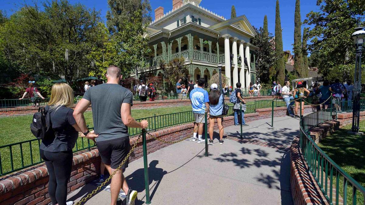 Disneyland visitors wait outside the Haunted Mansion in Anaheim, CA, on Friday, April 30, 2021.  (Photo by Jeff Gritchen, Orange County Register/SCNG)