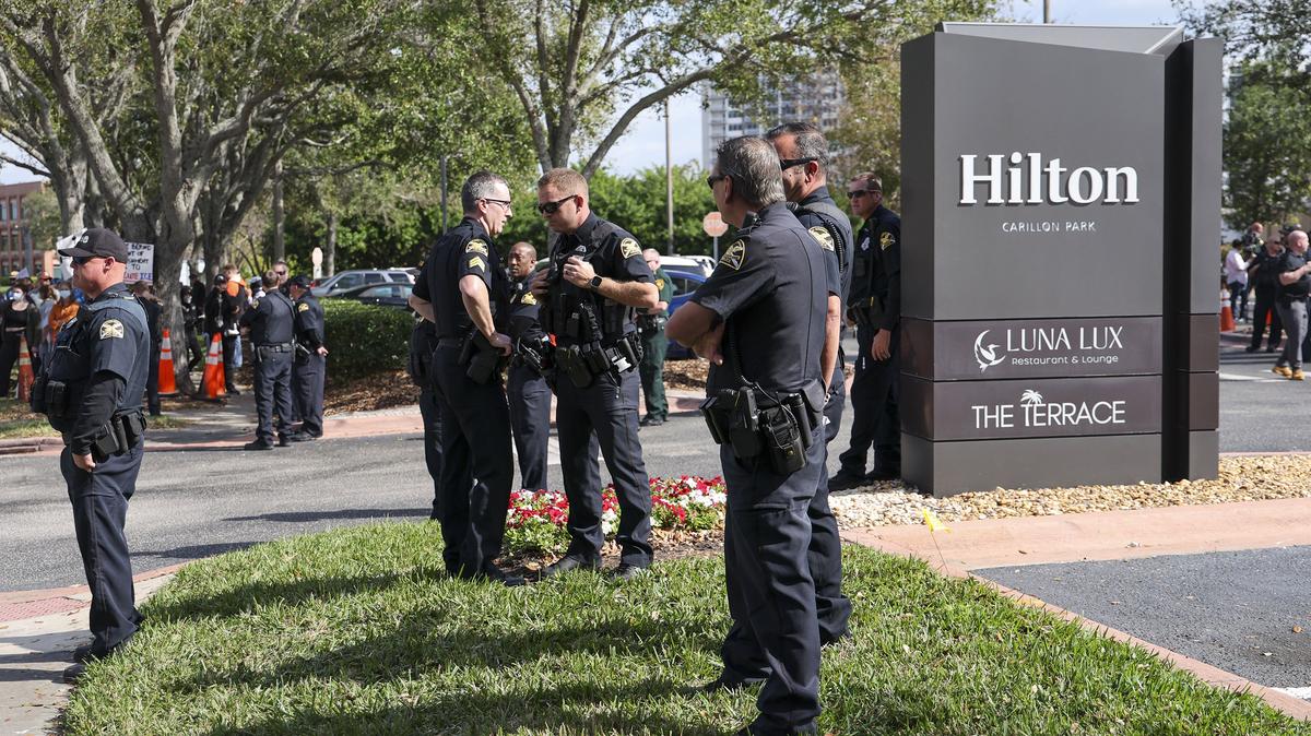 A group of St. Petersburg Police officers congregate outside the Carillon Park Hilton as protesters opposing a U.S. Customs and Border Protection recruitment event gather outside the hotel on Tuesday, Jan. 13, 2026, in St. Petersburg, Fla. (Douglas R. Clifford/Tampa Bay Times/TNS)