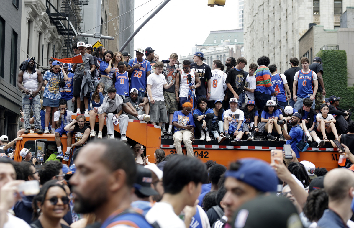 Basketball - NBA - New York Knicks Parade - New York City, New York, U.S. - June 18, 2026 New York Knicks fans on top of a truck during the parade REUTERS/Jeenah Moon
