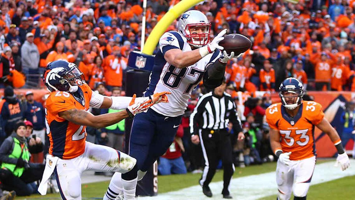  Jan 24, 2016; Denver, CO, USA; New England Patriots tight end Rob Gronkowski (87) catches a touchdown pass against Denver Broncos cornerback Chris Harris (25) in the fourth quarter in the AFC Championship football game at Sports Authority Field at Mile High. Mandatory Credit: Mark J. Rebilas-Imagn Images | Mark J. Rebilas-Imagn Images 