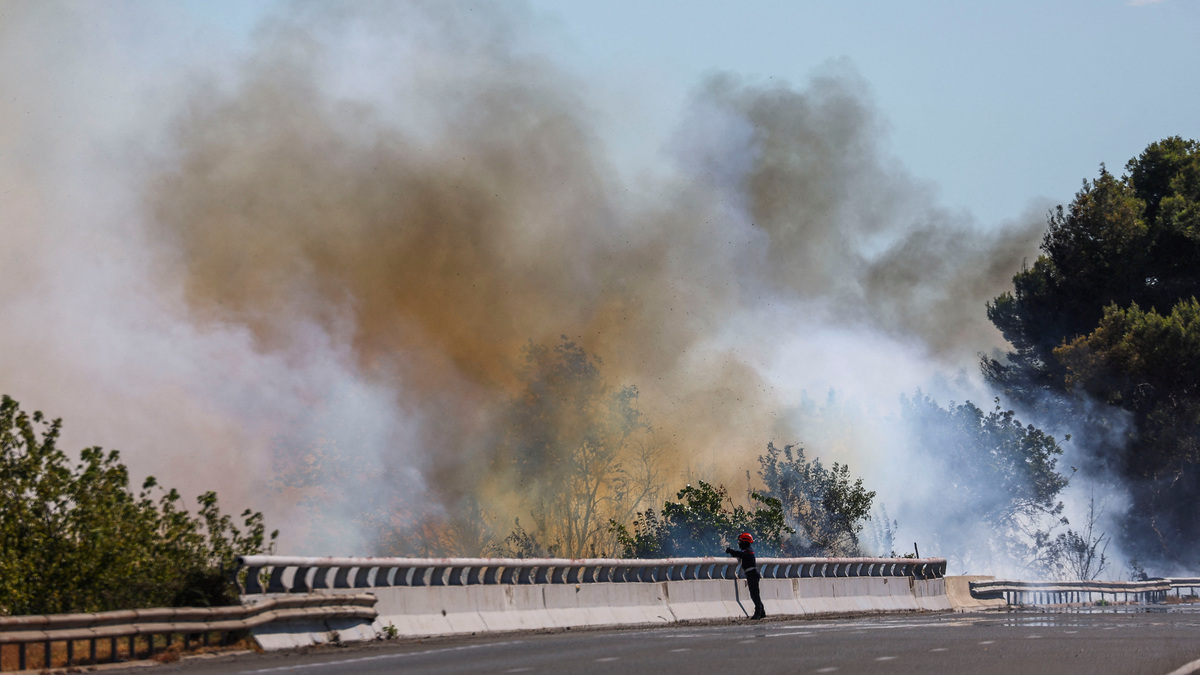 A firefighter works to battle wildfire near the A9 motorway near Beziers, France, July 3, 2026. REUTERS/Abdul Saboor