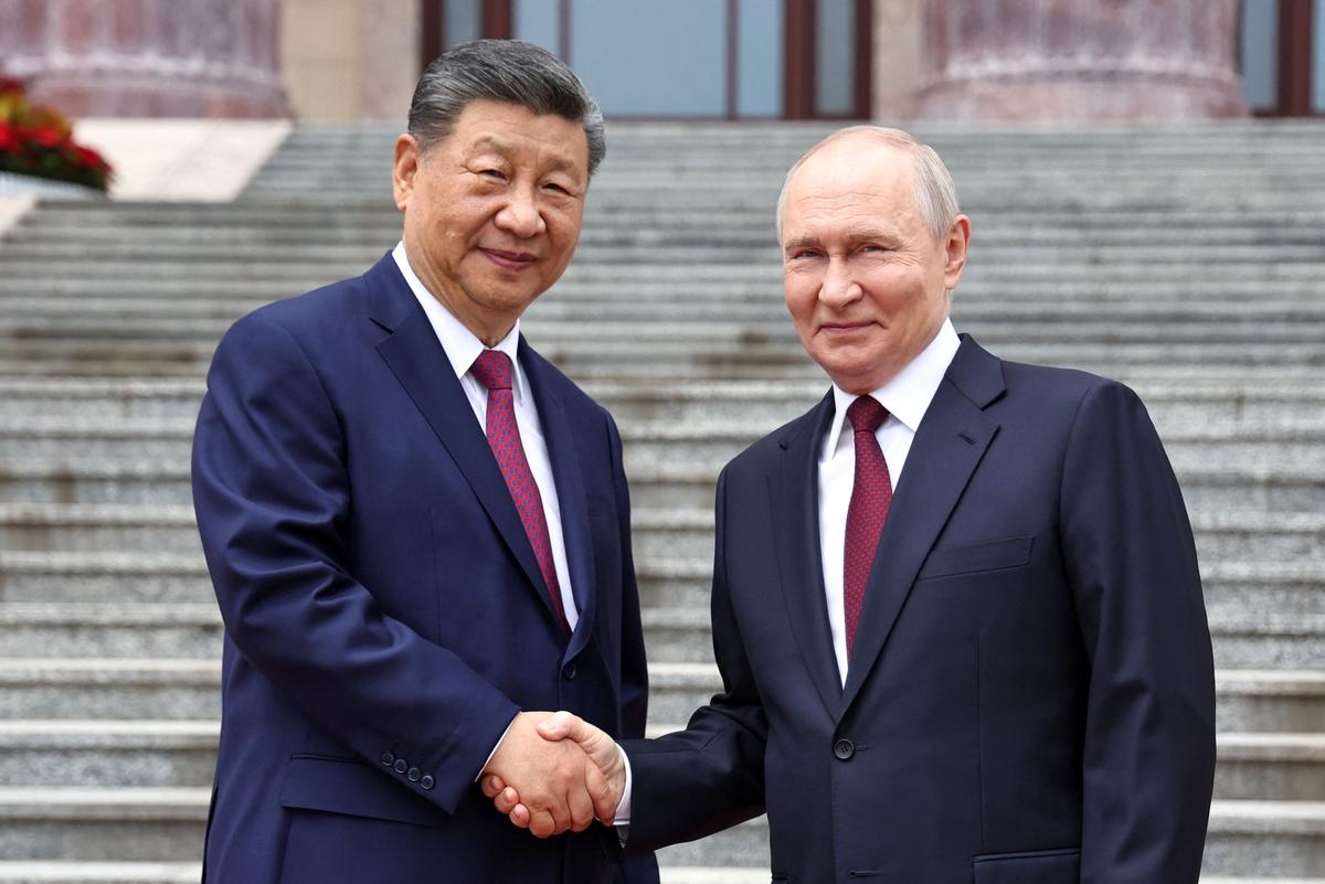 Russian President Vladimir Putin shakes hands with Chinese President Xi Jinping during a welcoming ceremony at the Great Hall of the People in Beijing, China May 20, 2026. Sputnik/Alexander Kazakov/Pool via REUTERS ATTENTION EDITORS - THIS IMAGE WAS PROVIDED BY A THIRD PARTY.