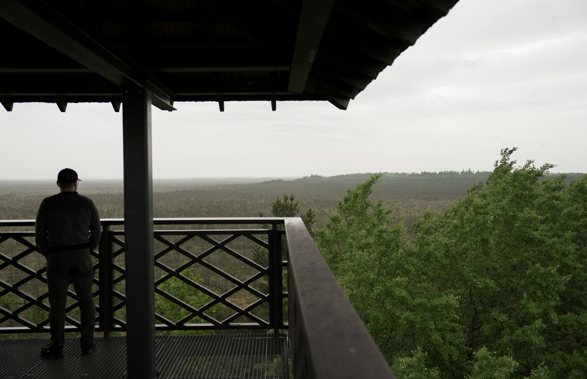A man stands on the observation platform in Atasiene parish, Latvia, June 8, 2026. REUTERS/Janis Laizans