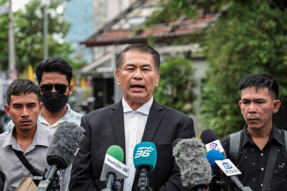 Lawyer Kunpat Singhathong representing Panithi Tumkaew, 43, Noppadon Wongsuvan, 33, and Surades Manpuen, 32, Thai crew members of the cargo ship Mayuree Naree that was struck on March 11, killing three crew members, while sailing through the Strait of Hormuz, speaks to the media at the Central Labour Court before filing a lawsuit accusing Thailand-based company Precious Shipping of ordering the vessel to sail through the waterway despite military tensions between the U.S. and Iran, in Bangkok, Thailand, July 10, 2026. REUTERS/Chalinee Thirasupa