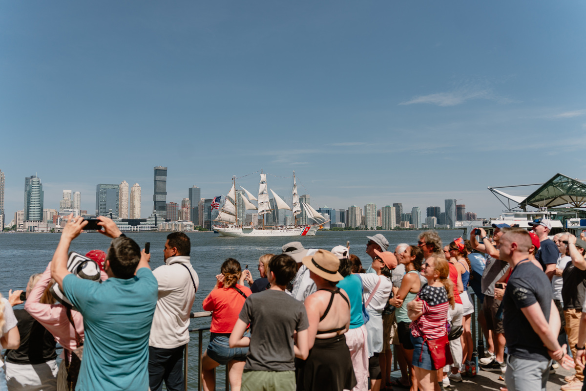 Spectators watch the International Aerial Review from Rockefeller Park in Lower Manhattan during the 250th anniversary of the United States' independence in New York, July 4, 2026. America celebrates the 250th anniversary of its independence today, with people from one end of the country to the other marking the milestone with fireworks, parades and concerts. (Lucia Vazquez/The New York Times)