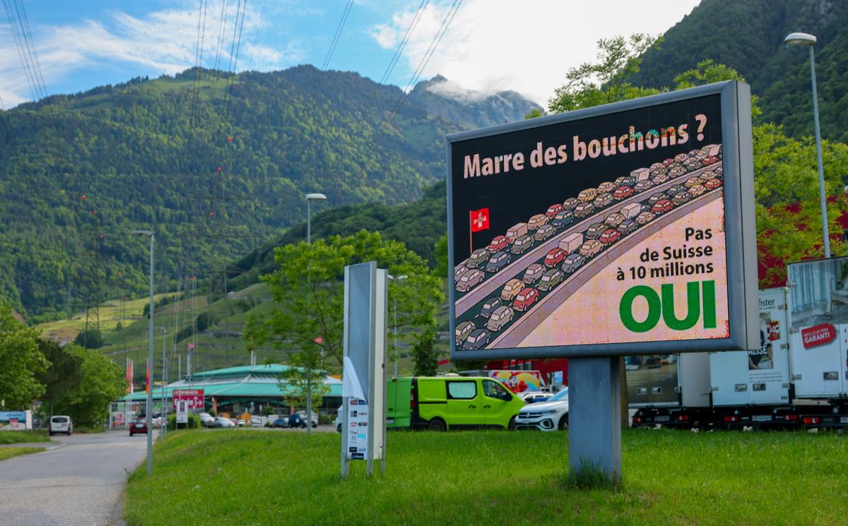 A sign is pictured ahead of a June 14 vote on a plan backed by the right-wing Swiss People's Party (SVP) to cap the population at 10 million inhabitants, in Villeneuve, Switzerland, May 13, 2026. The sign reads: "Fed up with traffic jams! No Switzerland with 10 million." REUTERS/Denis Balibouse