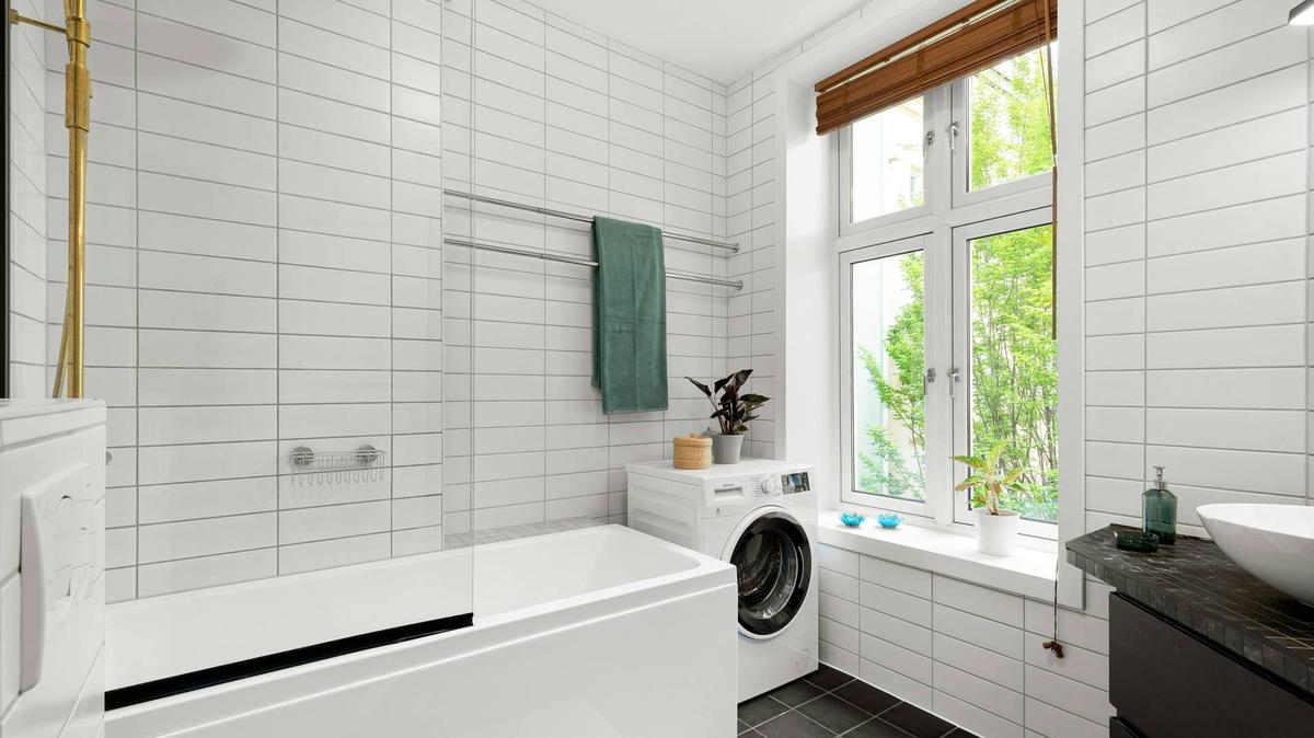 a white bathroom with subway tile.