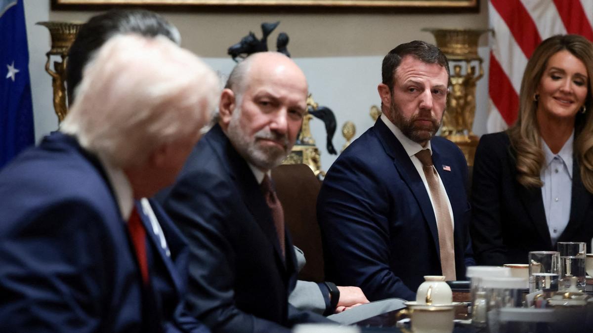 FILE PHOTO: U.S. President Donald Trump, Commerce Secretary Howard Lutnick, Secretary of Homeland Security Markwayne Mullin, and Small Business Administration Administrator Kelly Loeffler attend a cabinet meeting at the White House in Washington, D.C., U.S., March 26, 2026. REUTERS/Evelyn Hockstein/File Photo