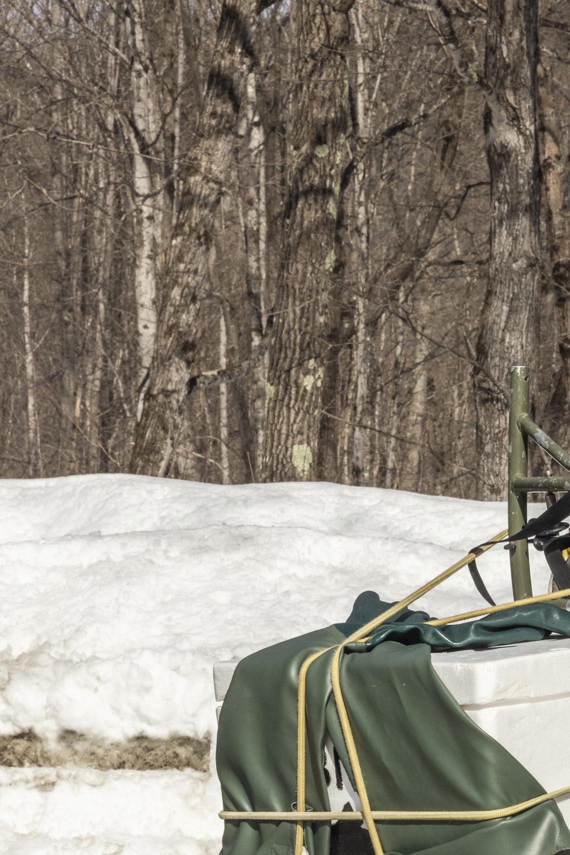 Hadley Couraud of the Nature Conservancy carries a cooler of salmon eggs and other supplies in Farmington, Maine, March 3, 2026. The fragile hope for salmon recovery in Maine: a long-term project to remove or modify dams may clear the way for endangered wild Atlantic salmon to swim freely up to the Sandy River, but it faces opposition from business and lawmakers. (Greta Rybus/The New York Times)