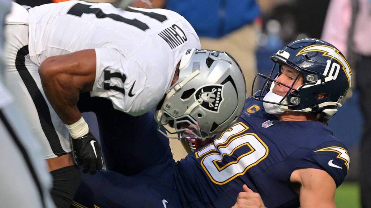  Nov 30, 2025; Inglewood, California, USA; Las Vegas Raiders safety Jeremy Chinn (11) tackles Los Angeles Chargers quarterback Justin Herbert (10) during the first half at SoFi Stadium. Mandatory Credit: Jayne Kamin-Oncea-Imagn Images | Jayne Kamin-Oncea-Imagn Images 