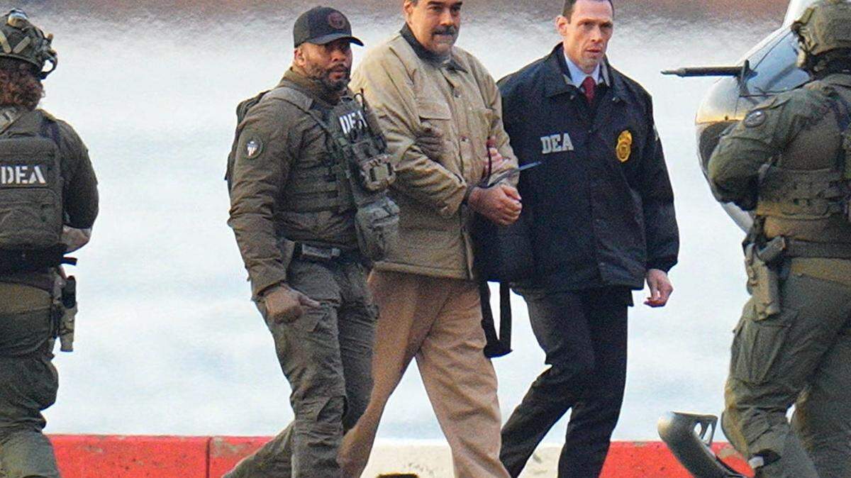 Venezuelan President Nicolas Maduro walks in handcuffs after landing at a New York City helipad, escorted by federal agents, as he and his wife make their way into an armored car en route to a federal courthouse on Monday. Two days after being captured by U.S. military forces, Maduro pleaded not guilty to federal charges, declaring himself a “prisoner of war.”