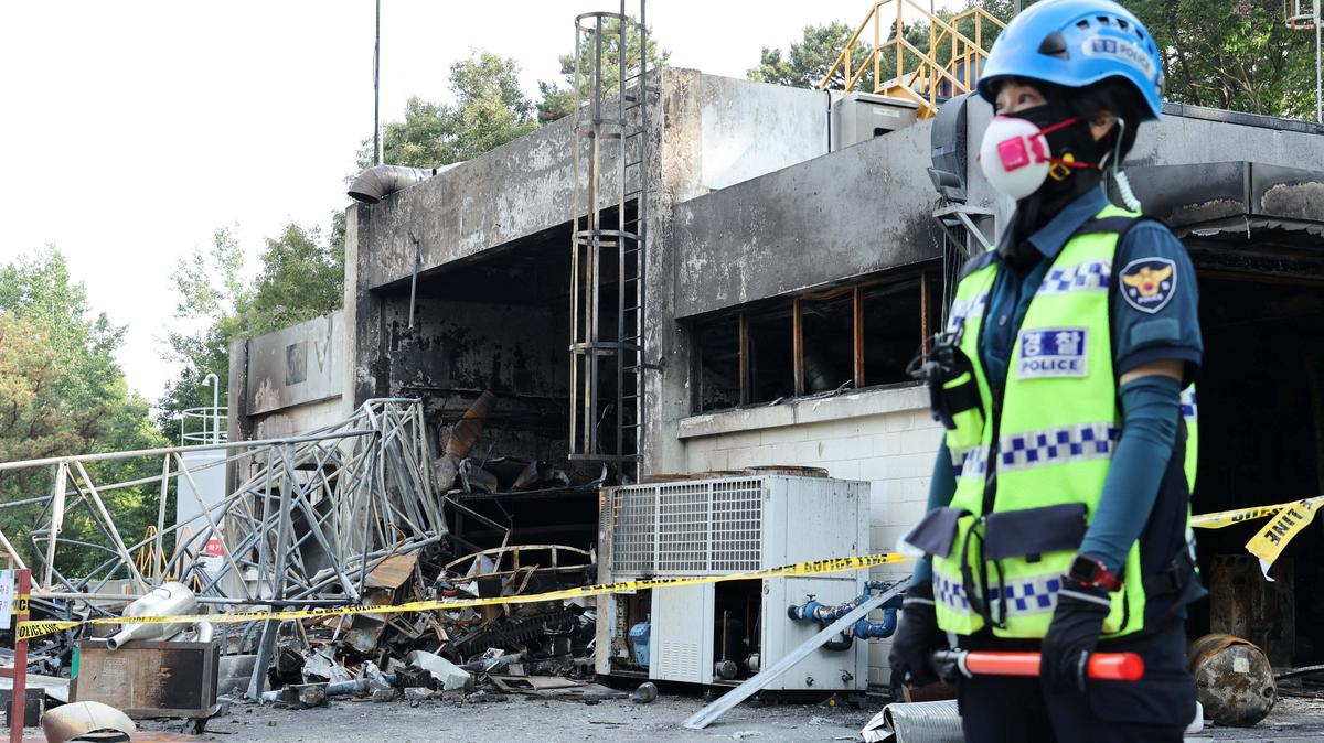 A police officer stands in front of heavily damaged production line for rocket propellant of Hanwha Aerospace's factory after an explosion, in Daejeon, South Korea, June 1, 2026.    Yonhap via REUTERS