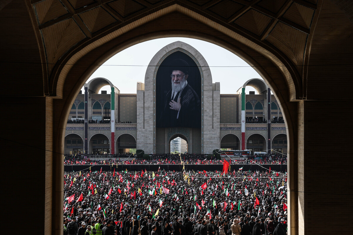 People wave flags as funeral ceremonies are held for Iran’s late Ayatollah Ali Khamenei on July 4 in Tehran, Iran. 