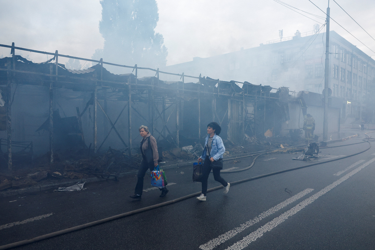 Women walk past a market which was hit during Russian missile and drone strikes, amid Russia's attack on Ukraine, in Kyiv, Ukraine June 15, 2026. REUTERS/Valentyn Ogirenko