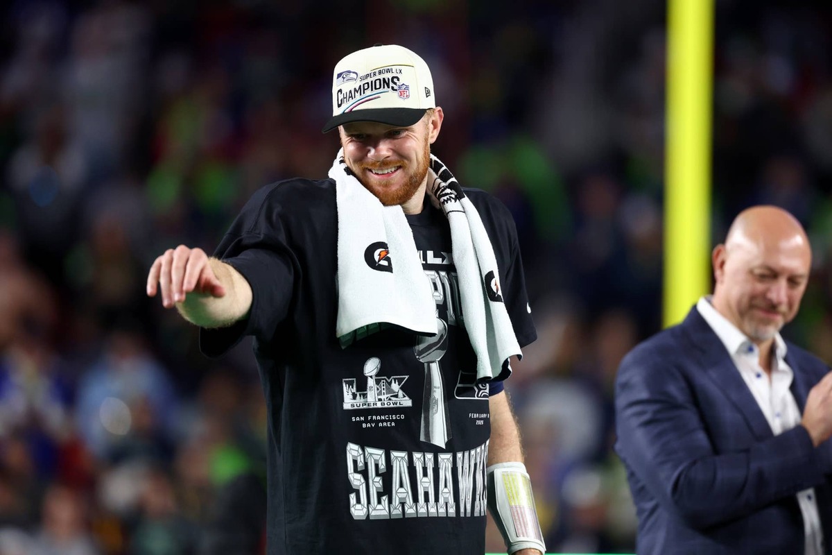  Seattle Seahawks quarterback Sam Darnold (14) celebrates on the podium after defeating the New England Patriots in Super Bowl LX at Levi's Stadium. Mark J. Rebilas-Imagn Images