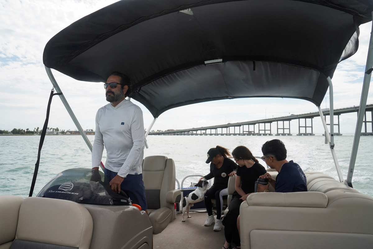 Eddie Reyes, his wife Liliana Pena, Viviana Espinoza, and Kriz Pena make their way to fish as they see SpaceX's rocket launch ahead of the company's initial public offering (IPO), in Port Isabel, Texas, U.S.  May 21, 2026.  REUTERS/Gabriel V. Cardenas