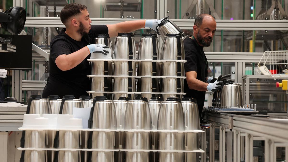 FILE PHOTO: Employees work at the Vorwerk factory producing Thermomix kitchen appliances in Donnemain-Saint-Mames, France, May 29, 2026. REUTERS/Christian Hartmann/Pool/File Photo