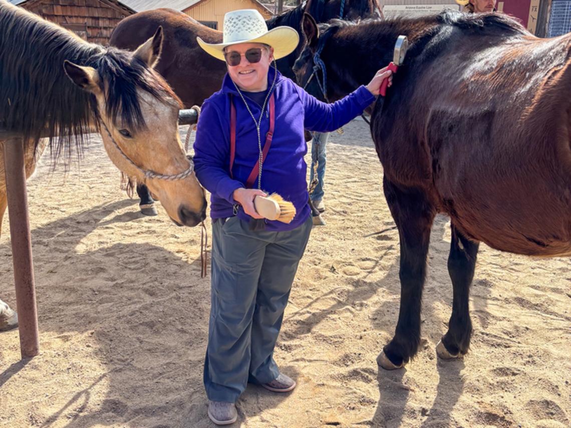 The author grooming Snip after a ride. Photo credit: Nikki, a guest