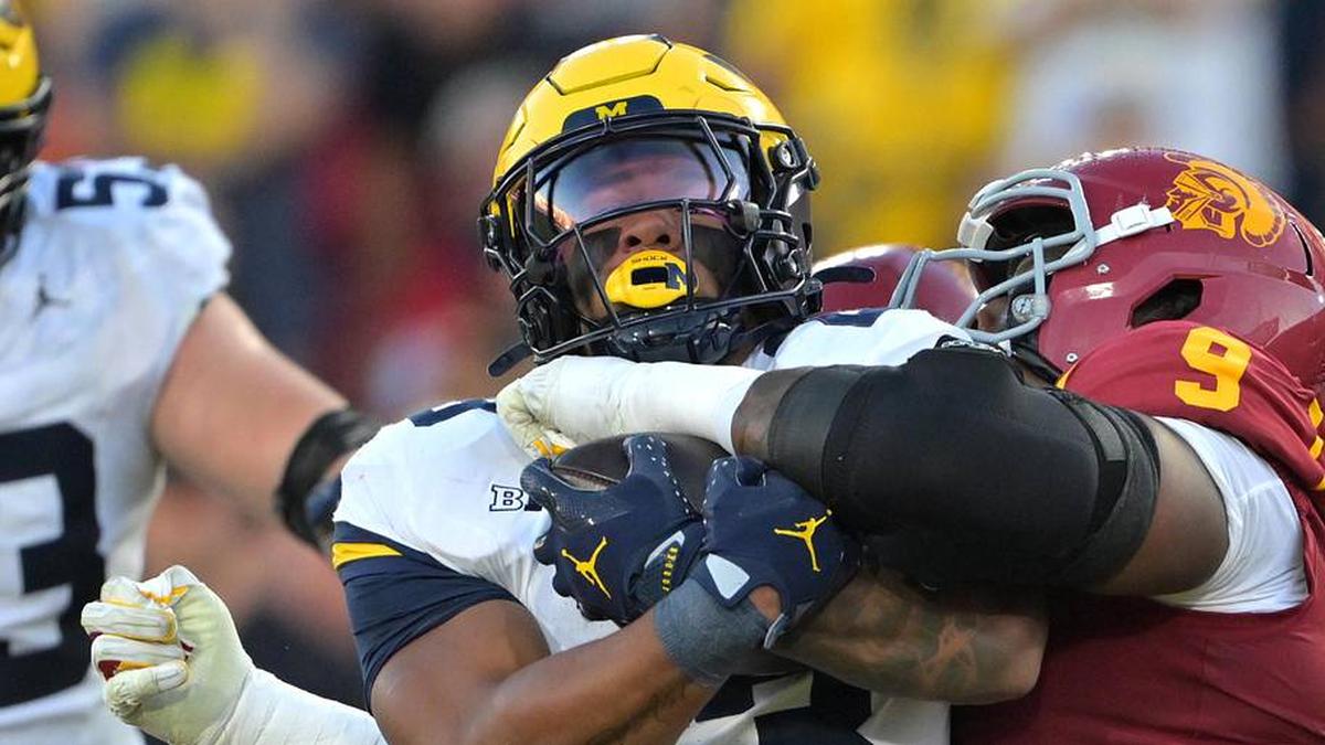  Oct 11, 2025; Los Angeles, California, USA; Michigan Wolverines running back Jordan Marshall (23) is stopped by USC Trojans defensive tackle Keeshawn Silver (9) at the 7-yard line in the first half at United Airlines Field at the Los Angeles Memorial Coliseum. | Jayne Kamin-Oncea-Imagn Images 