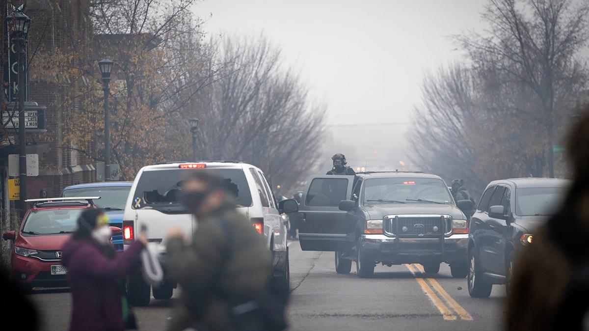 Law enforcement retreat south on Payne Avenue in a cloud of chemical irritants after an apparent federal raid at a home in St. Paul, Minnesota Nov. 25, 2025. (Leila Navidi/The Minnesota Star Tribune/TNS)