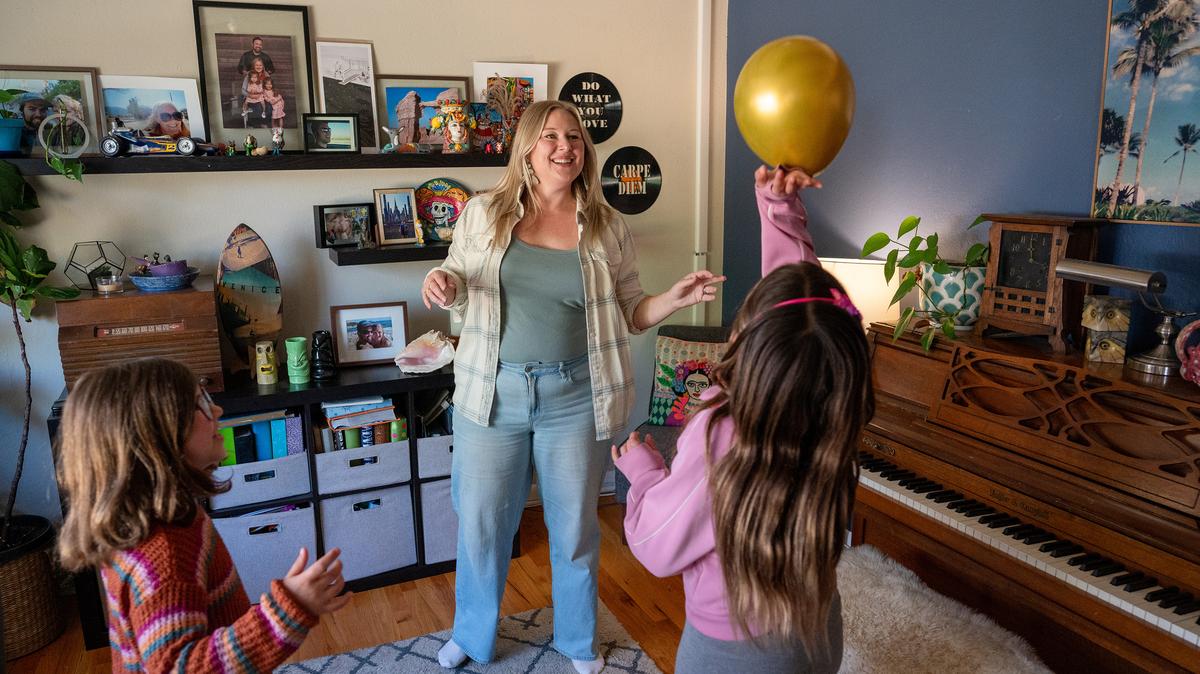 Sarah Freeman, center, plays with her daughters Maisy, 7, left, and Lula, 9, at their home in Wheat Ridge, Colo., on May 7, 2026. (Hyoung Chang/The Denver Post/TNS)