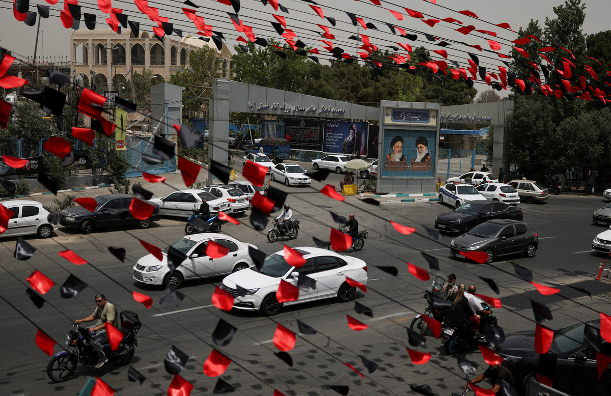 Red and black pennants hang above a street as vehicles pass by during preparations for a farewell ceremony for Iran's late Supreme Leader Ayatollah Ali Khamenei who was killed on February 28 in Israeli and U.S. airstrikes, otside the Imam Khomeini Grand Mosalla, in Tehran, Iran July 2, 2026. REUTERS/Mohammed Salem  Foreign media in Iran operate under guidelines set by the Ministry of Culture and Islamic Guidance, which regulates press activity and permissions