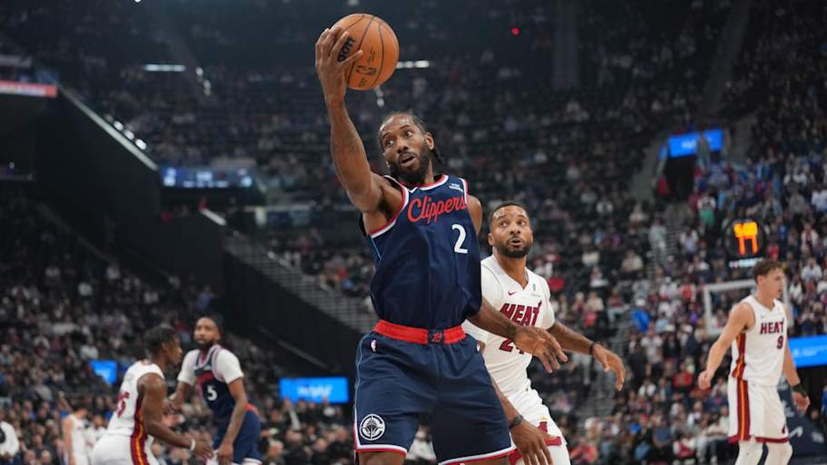 Nov 3, 2025; Inglewood, California, USA; LA Clippers forward Kawhi Leonard (2) reaches for the ball against Miami Heat guard Norman Powell (24) in the first half at Intuit Dome. Mandatory Credit: Kirby Lee-Imagn Images. 