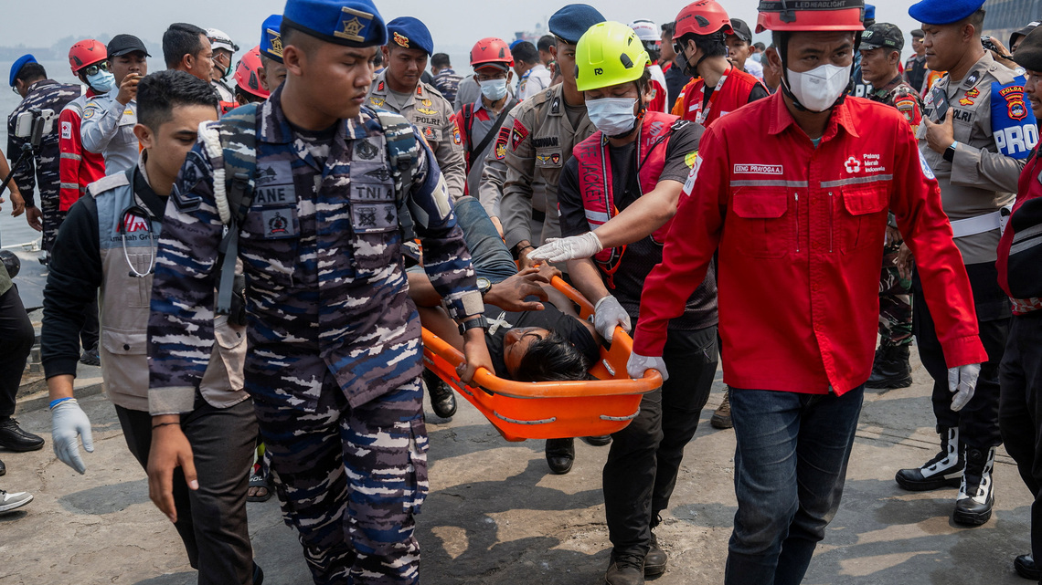 Indonesian rescuers plan to right capsized ship as weather hampers search for 129 missing people 