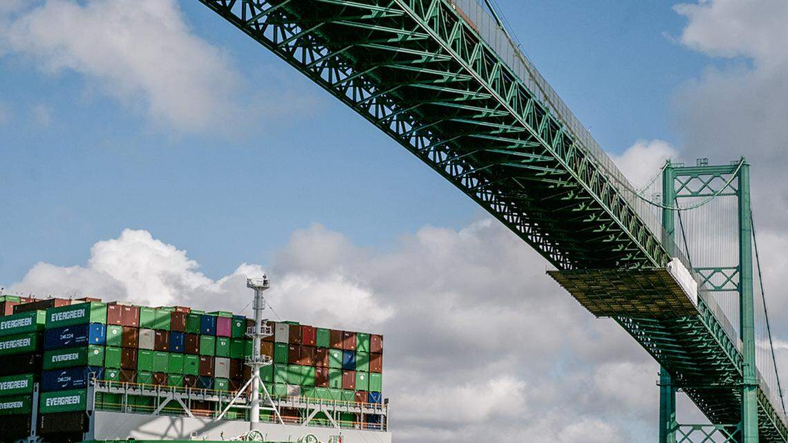 A ship carrying containers at the Port of Los Angeles on Feb. 14. President Donald Trump imposed new tariffs on Canada, Mexico and China Tuesday. The impact on California’s economy is unclear, a new study says.