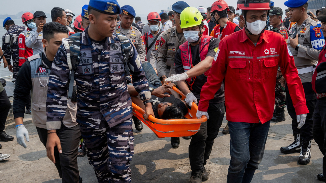 Indonesia divers face high-risk challenges to reach sunken ferry 