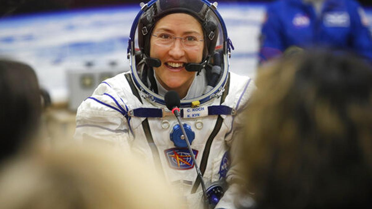 FILE - In this Thursday, March 14, 2019 file photo, U.S. astronaut Christina Koch, member of the main crew of the expedition to the International Space Station (ISS), speaks with her relatives through a safety glass prior the launch of Soyuz MS-12 space ship at the Russian leased Baikonur cosmodrome, Kazakhstan. Koch will remain on board until February, approaching but not quite breaking Scott Kelly’s 340-day U.S. record.