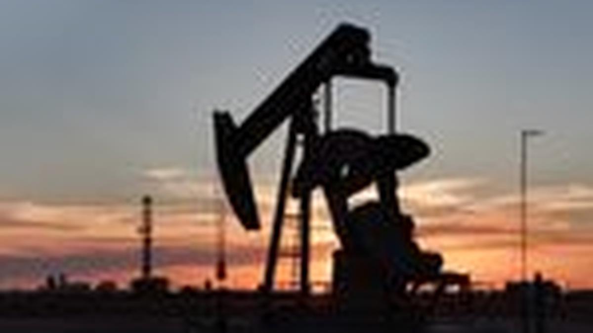 FILE PHOTO: A drone view of a pump jack and drilling rig south of Midland, Texas, U.S. June 11, 2025. REUTERS/Eli Hartman/File Photo