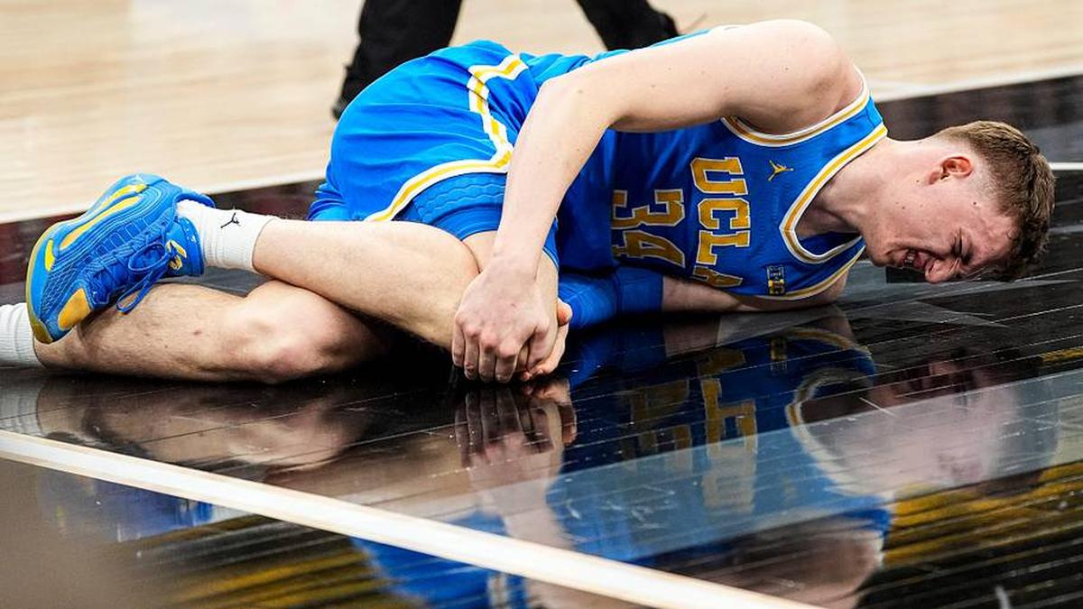  UCLA forward Tyler Bilodeau (34) falls on the court due to injury during the first half of Big Ten tournament quarterfinal against Michigan State at United Center in Chicago on Friday, March 13, 2026. | Junfu Han / USA TODAY NETWORK via Imagn Images 