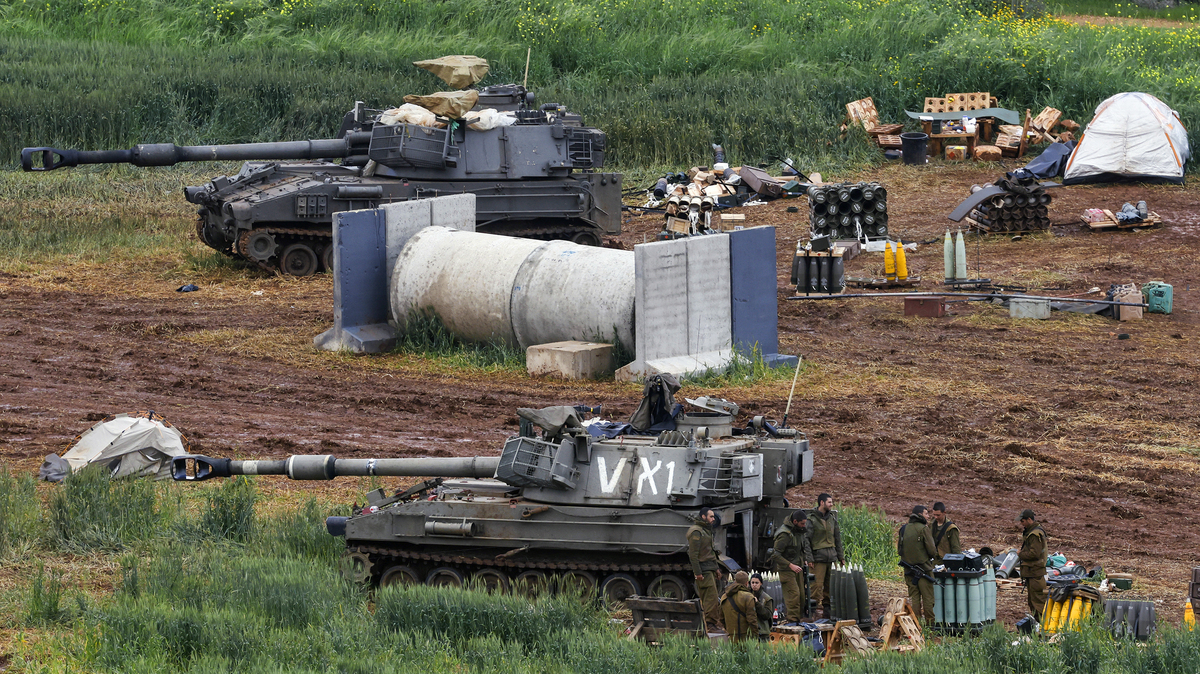 Israeli army soldiers stand next to a self-propelled Howitzer artillery gun positioned in the upper Galilee in northern Israel near the border with southern Lebanon on March 29, 2026. Lebanon was drawn into the Middle East war on March 2, when pro-Iran Hezbollah launched rockets towards Israel in response to US-Israeli strikes that killed Iranian supreme leader on February 28. (Jalaa Marey/AFP/Getty Images/TNS)